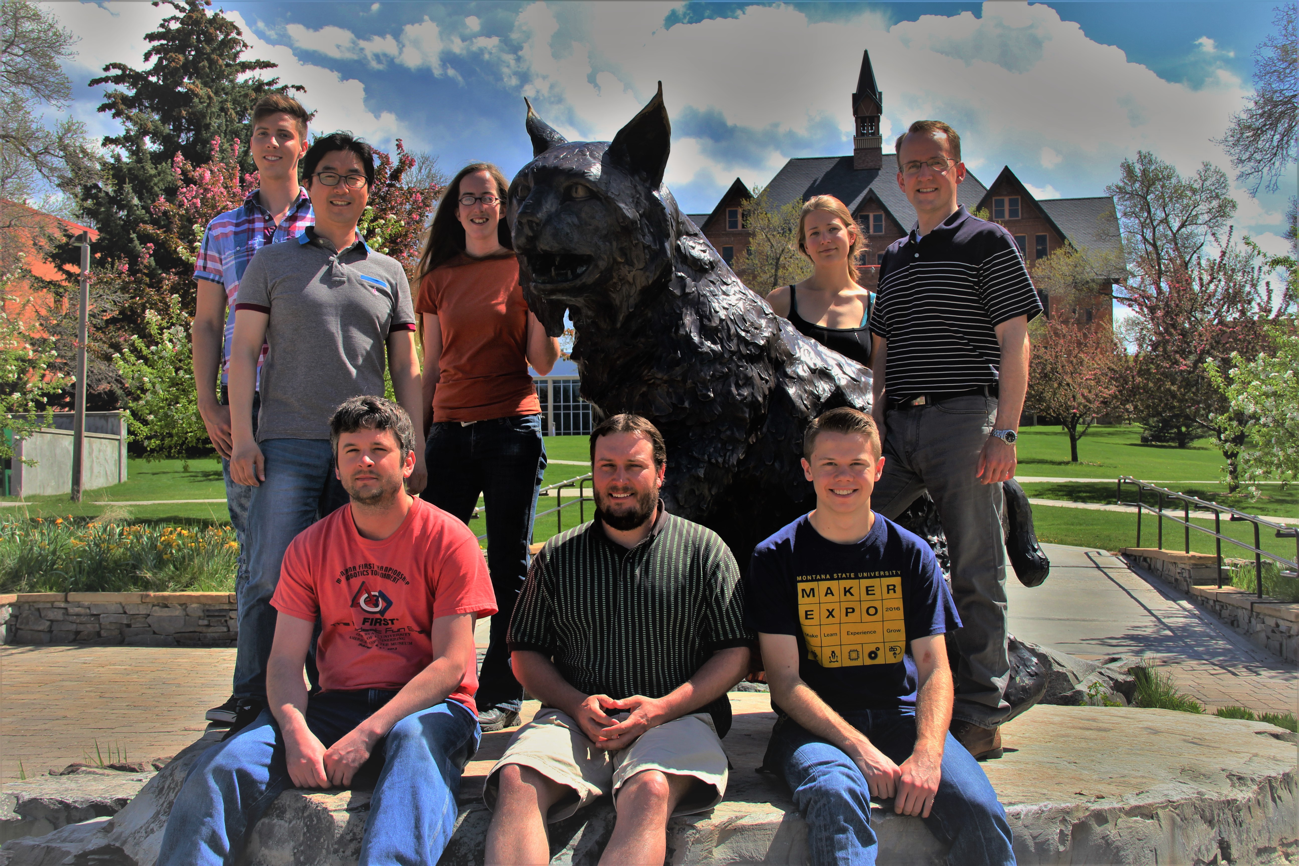 Members of the Biochemical Engineering Lab standing around Spirit the bobcat.