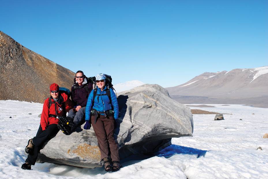 Christine Foreman and Heidi Smith sitting on rock in Antarctica